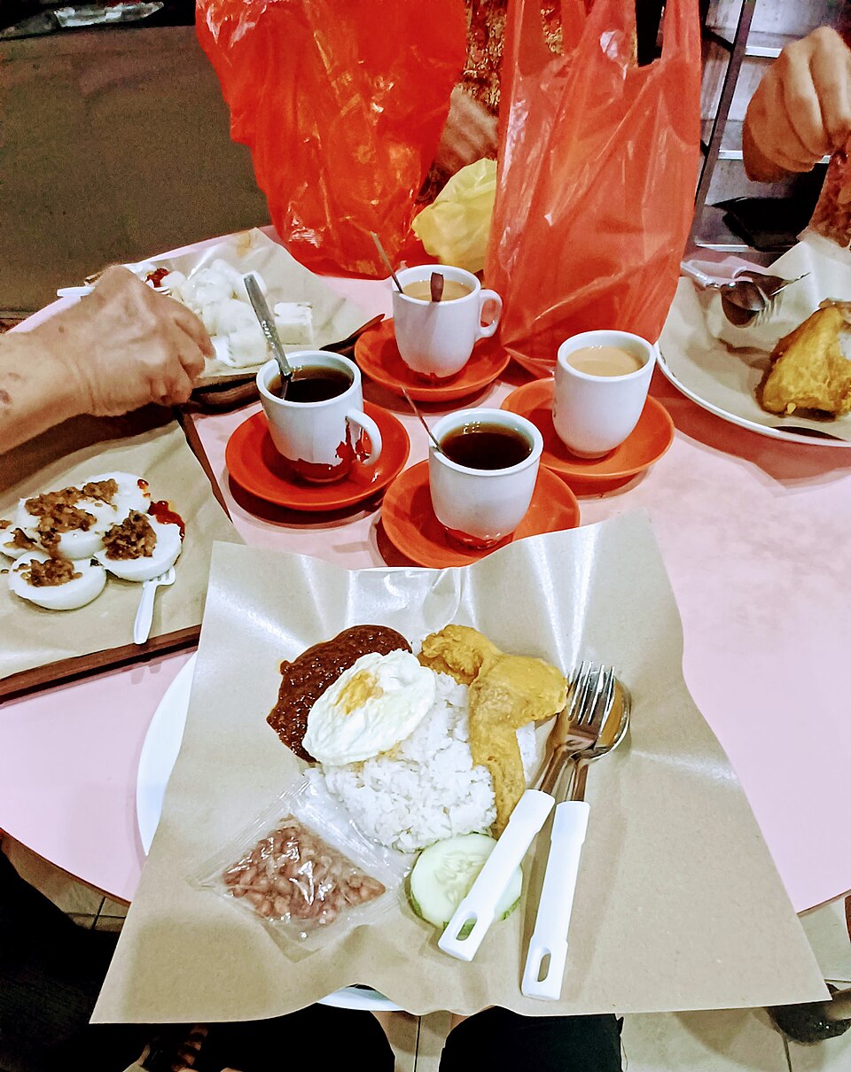 Four figures enjoy breakfast and coffee at a local diner.