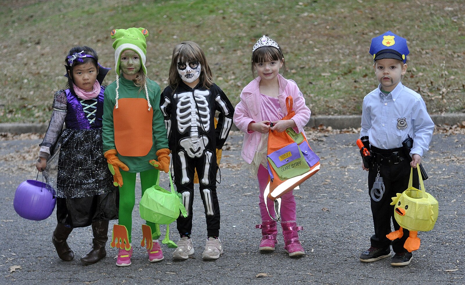 Children dressed up on an ideal Halloween day in vibrant costumes, ready to go trick-or-treating.