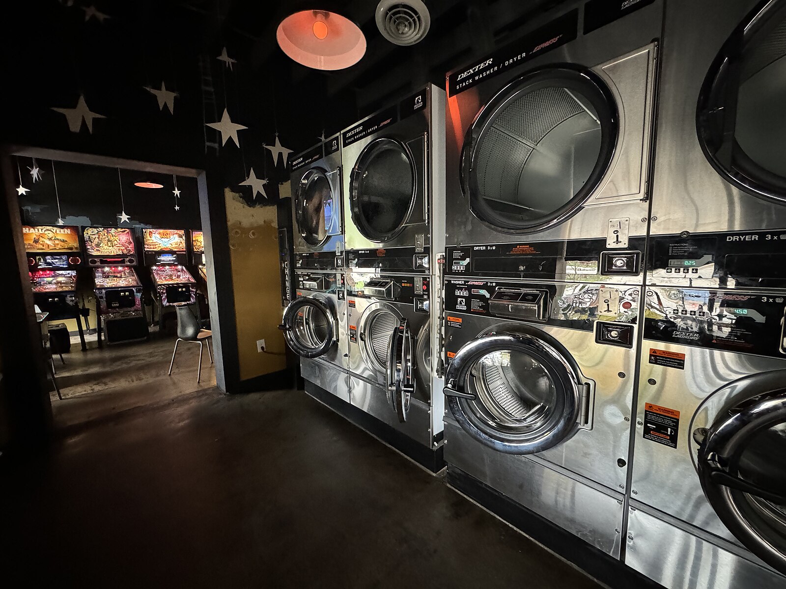 A funky room stuffed with eight laundry rooms opens up into a restaurant/VLT.