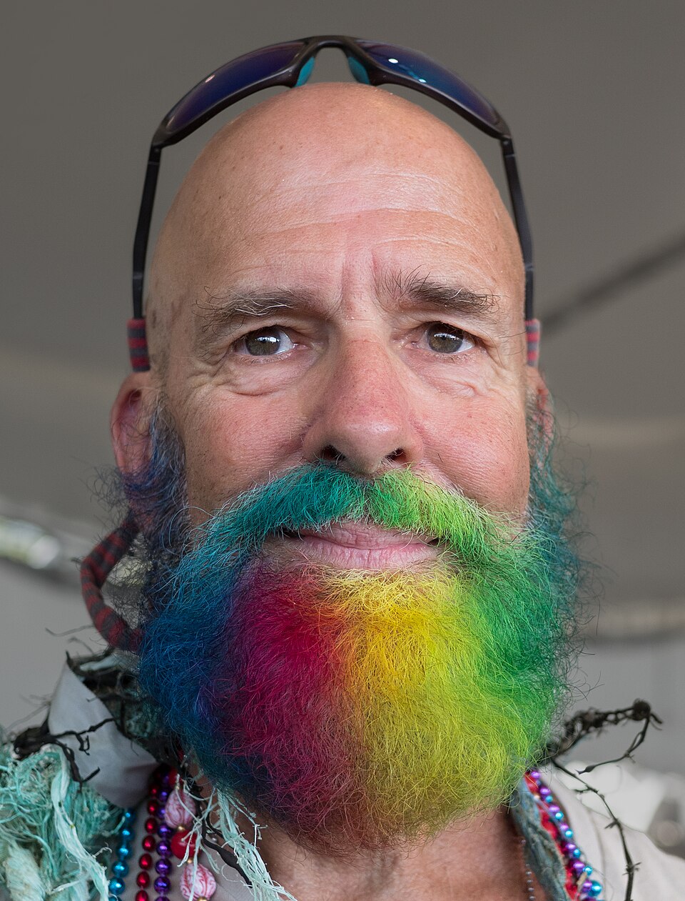Someone has dyed their mustache and beard using vibrant rainbow colours!